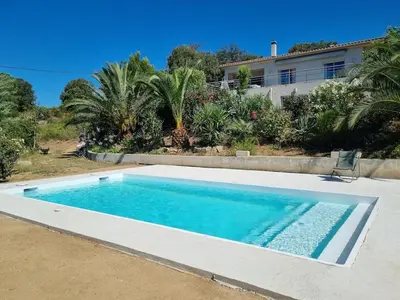 a swimming pool in front of a house at T2, rez de villa avec piscine in Afa