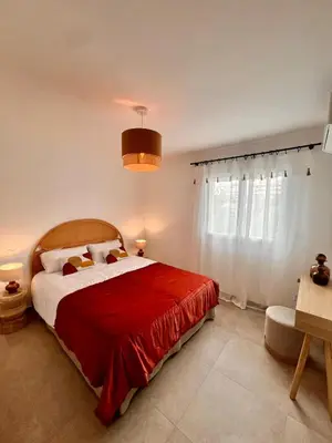 a bedroom with a large bed with a red blanket at Appartement CASA VISTA splendide vue sur le Golfe in Porto-Vecchio