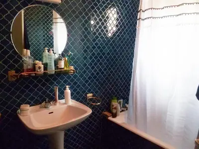 a bathroom with a sink and a mirror at Spacieuse villa avec vue exceptionnelle in Piana