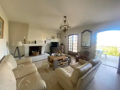 a living room with a couch and a fireplace at Spacieuse villa avec vue exceptionnelle in Piana