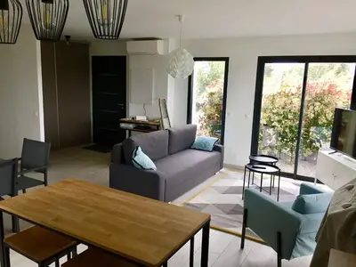 a living room with a couch and a table at Appartement T3 L'Astragale - Classé 3 étoiles Tourisme in Lecci
