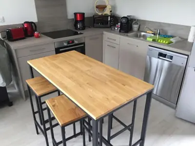 a kitchen with a wooden table and a sink at Appartement T3 L'Astragale - Classé 3 étoiles Tourisme in Lecci