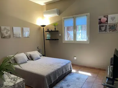 a bedroom with a bed and a window at Délice du maquis Corse in Porto-Vecchio