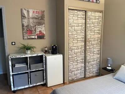 a room with a white refrigerator and a window at Délice du maquis Corse in Porto-Vecchio