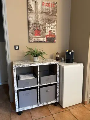 a white cart with drawers and a picture on the wall at Délice du maquis Corse in Porto-Vecchio