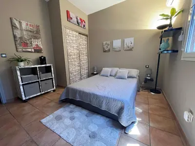 a bedroom with a bed with white sheets and pillows at Délice du maquis Corse in Porto-Vecchio
