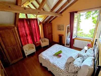 a bedroom with a bed and a large window at Holiday Apartment Segura 2 in Oletta