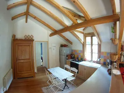 a kitchen with a table and chairs in a room at Holiday Apartment Segura 2 in Oletta