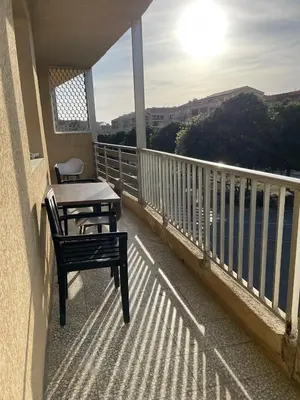 a balcony with a table and chairs on a balcony at Appartement 3 chambres in Propriano