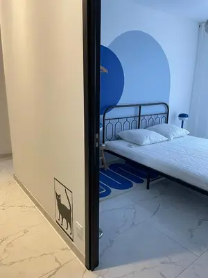a bedroom with a bed and a blue wall at Appartement 3 chambres in Propriano