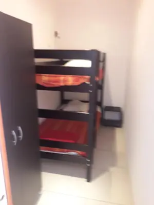 a room with a shelf in a room at Briloc Appartements Pietrosella à 50m de la plage in Pietrosella