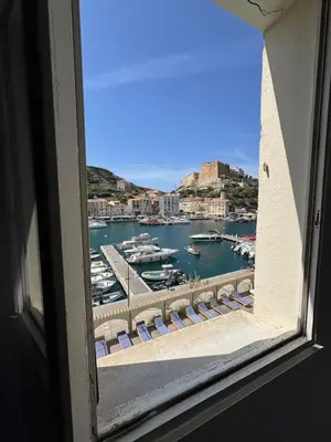a view of a harbor from a window at L'Ancrage - TV, Vue sur le port, Wi-Fi in Bonifacio