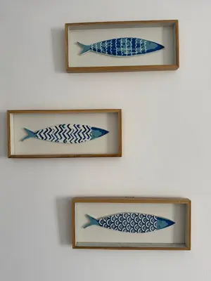 three framed pictures of fishes on a wall at L'Ancrage - TV, Vue sur le port, Wi-Fi in Bonifacio