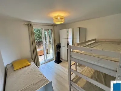 a room with two bunk beds and a refrigerator at VILLA GIULIA - Piscine - Jacuzzi - 4 Chambres in Porto-Vecchio