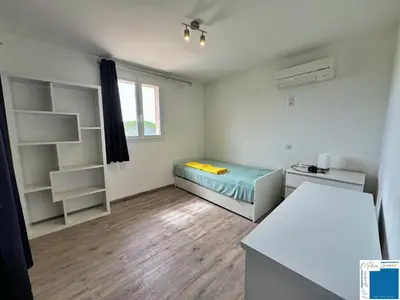 a small room with a bed and a desk at VILLA GIULIA - Piscine - Jacuzzi - 4 Chambres in Porto-Vecchio