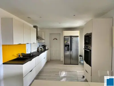 a kitchen with white cabinets and a stainless steel refrigerator at VILLA GIULIA - Piscine - Jacuzzi - 4 Chambres in Porto-Vecchio