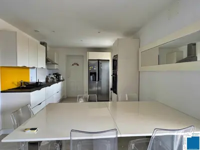 a kitchen with a large white table and chairs at VILLA GIULIA - Piscine - Jacuzzi - 4 Chambres in Porto-Vecchio