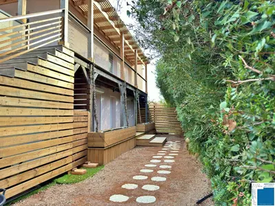 a house with a pathway next to a building at VILLA GIULIA - Piscine - Jacuzzi - 4 Chambres in Porto-Vecchio
