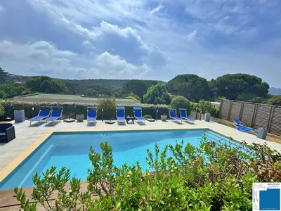 a swimming pool with blue lounge chairs and trees at VILLA GIULIA - Piscine - Jacuzzi - 4 Chambres in Porto-Vecchio