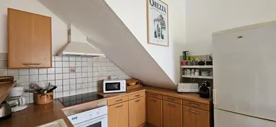 a kitchen with a white refrigerator and a microwave at T1 Pinedda, Studio confort-Vue mer- Calme & soleil in Propriano