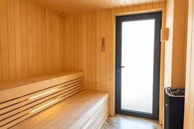 an empty sauna with a door and a window at Villa Lume Di Palombaggia in Musoleu