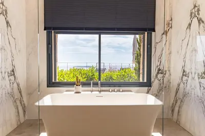 a bath tub in a bathroom with a window at Villa Lume Di Palombaggia in Musoleu