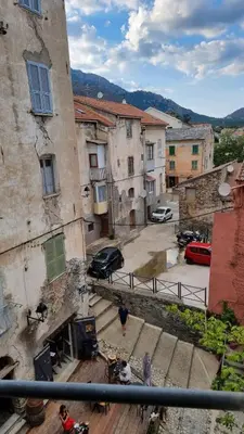 a group of people walking down the steps of a building at Appartement Corte centre ville in Corte