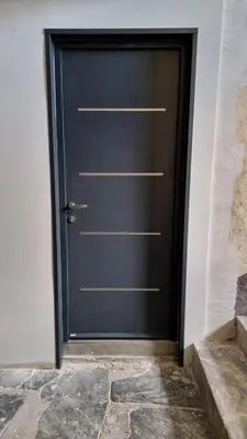 a black door in a room with a stone floor at Appartement Corte centre ville in Corte