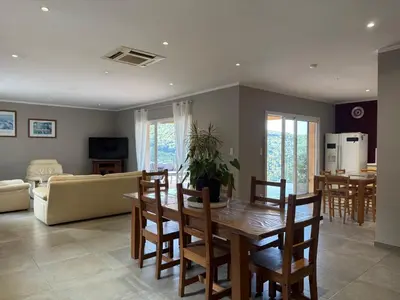 a dining room and living room with a table and chairs at Gîte Inseme, le calme entre mer et montagne en Corse in Arbellara