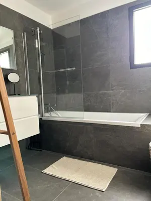 a bathroom with a shower and a bath tub at Villa H in Casanova