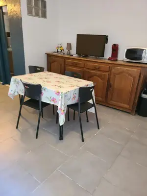 a table with two chairs and a table with a floral table cloth at Casinu - Casino in San-Nicolao
