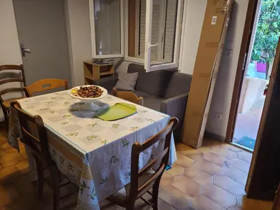 a dining room table with a plate of food on it at Casinu - Casino in San-Nicolao