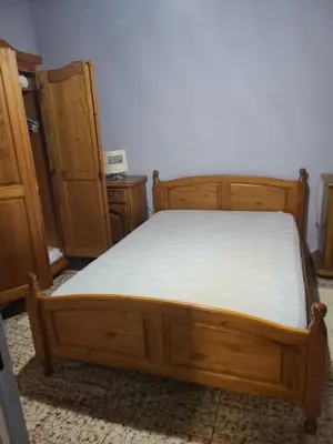 a wooden bed in a room with wooden furniture at Casinu - Casino in San-Nicolao