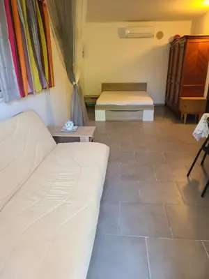 a living room with two beds and a couch at Casinu - Casino in San-Nicolao