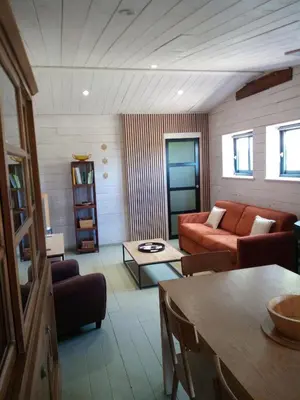 a living room with a couch and a table at La Ferme Du Maquis in Antisanti