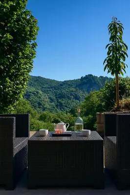 a table with a bottle of wine and a glass at Tour avec rooftop, vue mer, séjour insolite entre ciel et mer in Porri