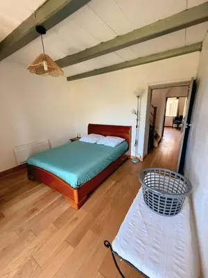 a bedroom with a bed and a basket in a room at Tour avec rooftop, vue mer, séjour insolite entre ciel et mer in Porri