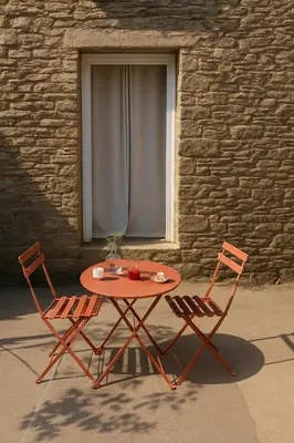 a table and two chairs sitting in front of a window at Tour avec rooftop, vue mer, séjour insolite entre ciel et mer in Porri