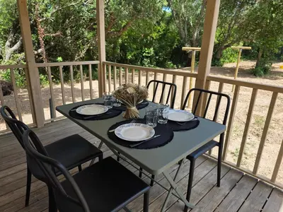 a blue table with chairs and plates on a deck at La Vigne in Lecci