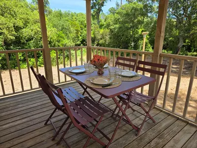 a purple table and chairs on a wooden deck at La Vigne in Lecci