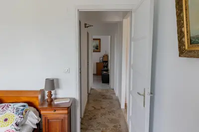 a hallway with a room with a bed and a table at Sagone Appartement T3 in Coggia