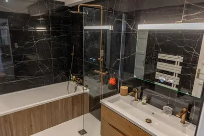 a bathroom with a sink and a shower and a tub at Sagone Appartement T3 in Coggia
