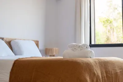 a bedroom with a bed with two towels on it at Bergerie entre plage et maquis in Zonza