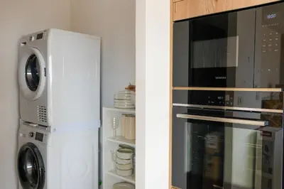 a microwave and a refrigerator in a kitchen at Bergerie entre plage et maquis in Zonza