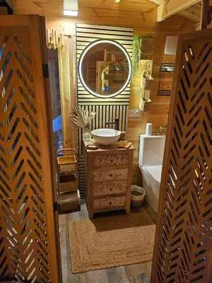 a bathroom with a sink and a mirror at Le cabanon de casaOma in Prunelli-di-Fiumorbo