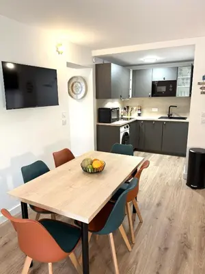 a kitchen and dining room with a wooden table and chairs at Fiori di Cala Rossa Signature in Lecci