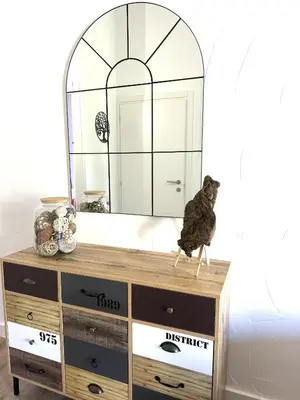 a bird sitting on a dresser in front of a mirror at Fiori di Cala Rossa Signature in Lecci