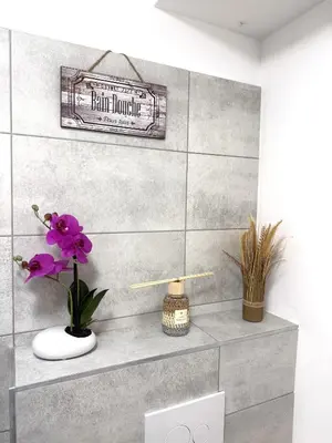 a bathroom with a shelf with a sign on the wall at Fiori di Cala Rossa Signature in Lecci