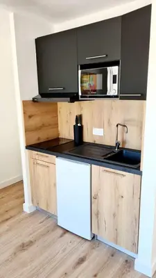 a kitchen with a sink and a microwave at Fiori di Cala Rossa Signature in Lecci