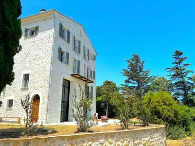 an old stone building with trees in front of it at Villa Padulone in Aléria